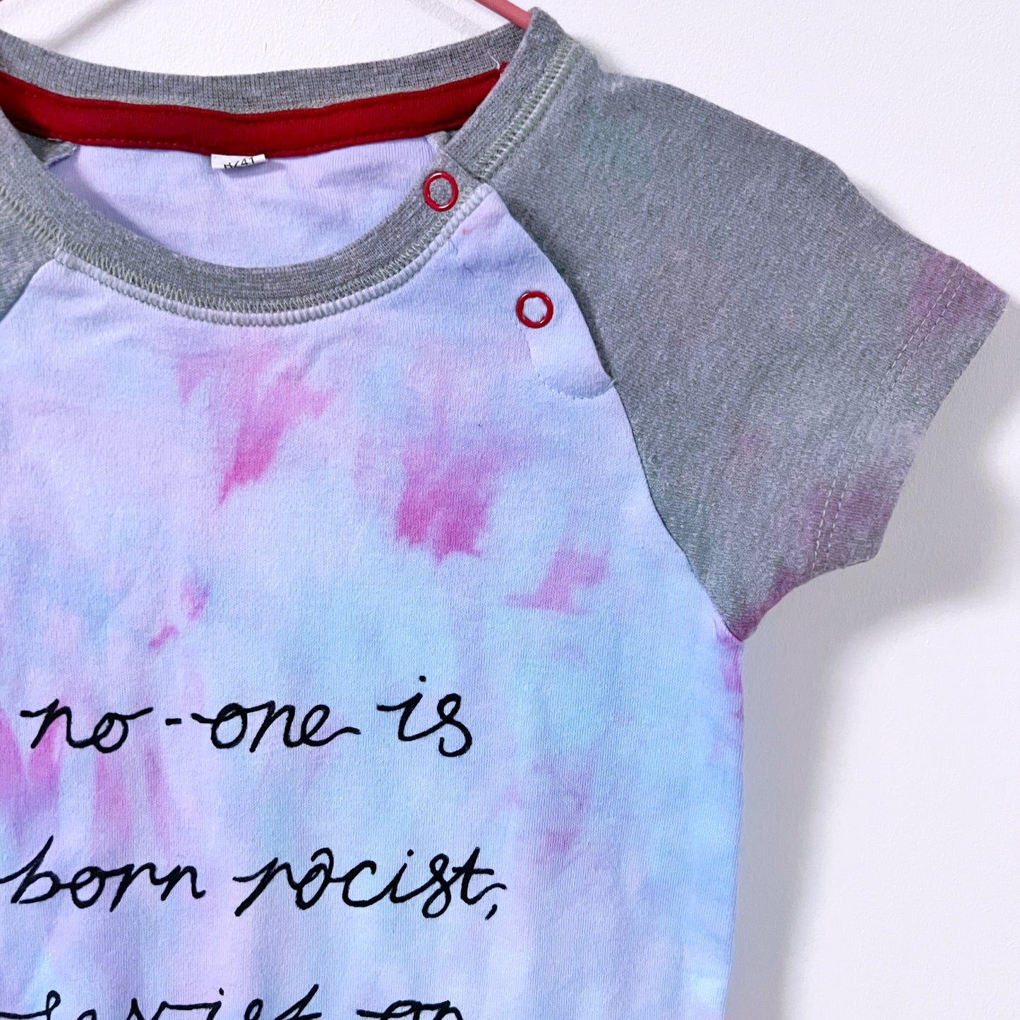 hate is taught... tie dye baby bodysuit